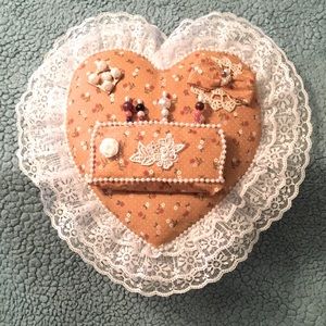 Handmade pin cushion/ 13” T x 13” W orange with rust, white & pink flowers.